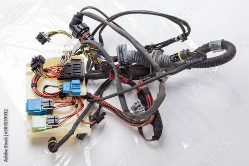 A cable of matted wires of different colors with connectors in the electrical wiring of the car. Internet line in the work of the provider.