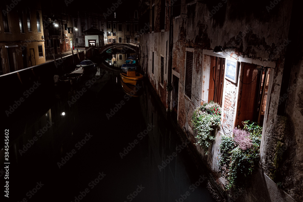 illuminated window at night on canal front in venice