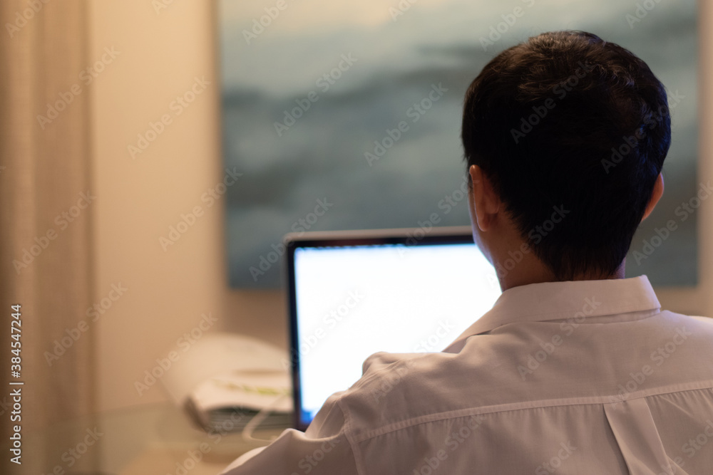 Business man using smartphone with Google search engine on web page app and Notebook laptop computer screen with Facebook page, working at night .Data Privacy Day.. Business man using smartphone with Google search engine on web page app and Notebook laptop computer screen with Facebook page, working at night .Data Privacy Day..