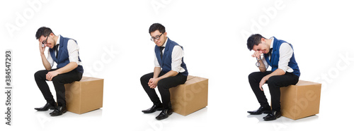 Young employee sitting on the box isolated on white