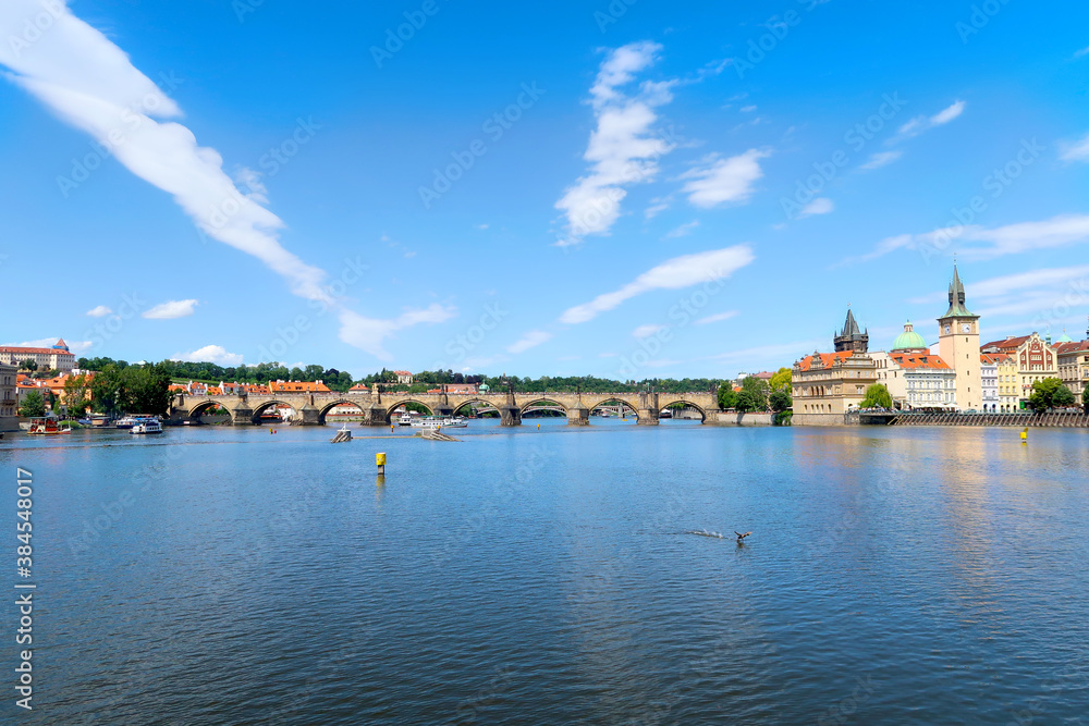 River Vltava with Charles Bridge in the background view from the deck of the tourist boat, sightseeing cruise in Prague, Czech Republic, boheman region.