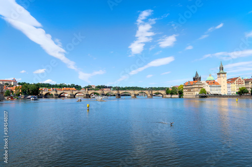 River Vltava with Charles Bridge in the background view from the deck of the tourist boat, sightseeing cruise in Prague, Czech Republic, boheman region. © hancik