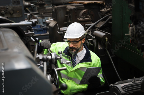 A Engineer inspect or checking or adjust or operate control the machine in workshop factory, the technician repair or maintenance part or equipment 