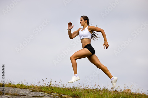 Bilde på lerret Determined Athlete Running On Mountain Against Sky