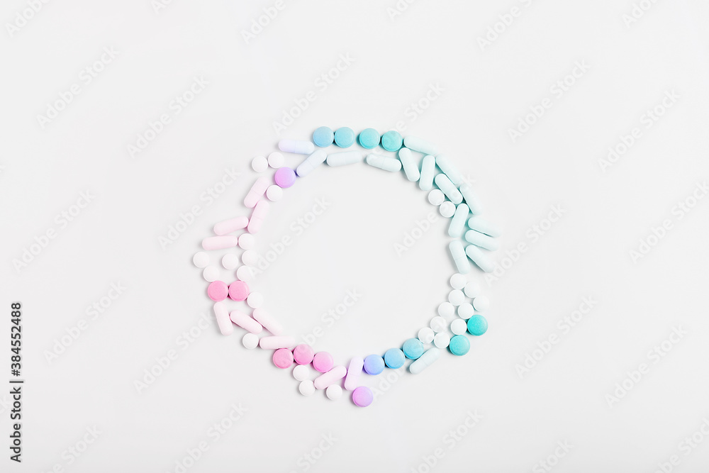 minimal concept. frame of pills and capsules of pastel gradient color on a white background. vitamin skincare, creative layout, copy space minimal concept. frame of pills and capsules of pastel gradient color on a white background. vitamin skincare, creative layout, copy space
