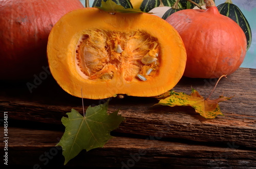 Cut in half orange  pumpkin on a wooden board background