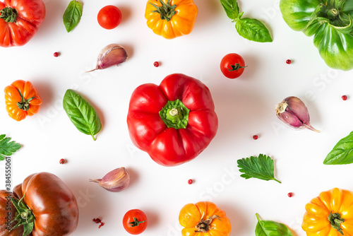 Tomato, pepper, basil, spices, garlic. Vegan diet food. Creative composition on white background. Organic vegetables