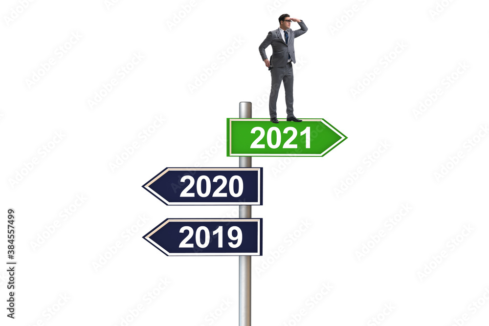 Road sign and businessman with 2020 and 2021
