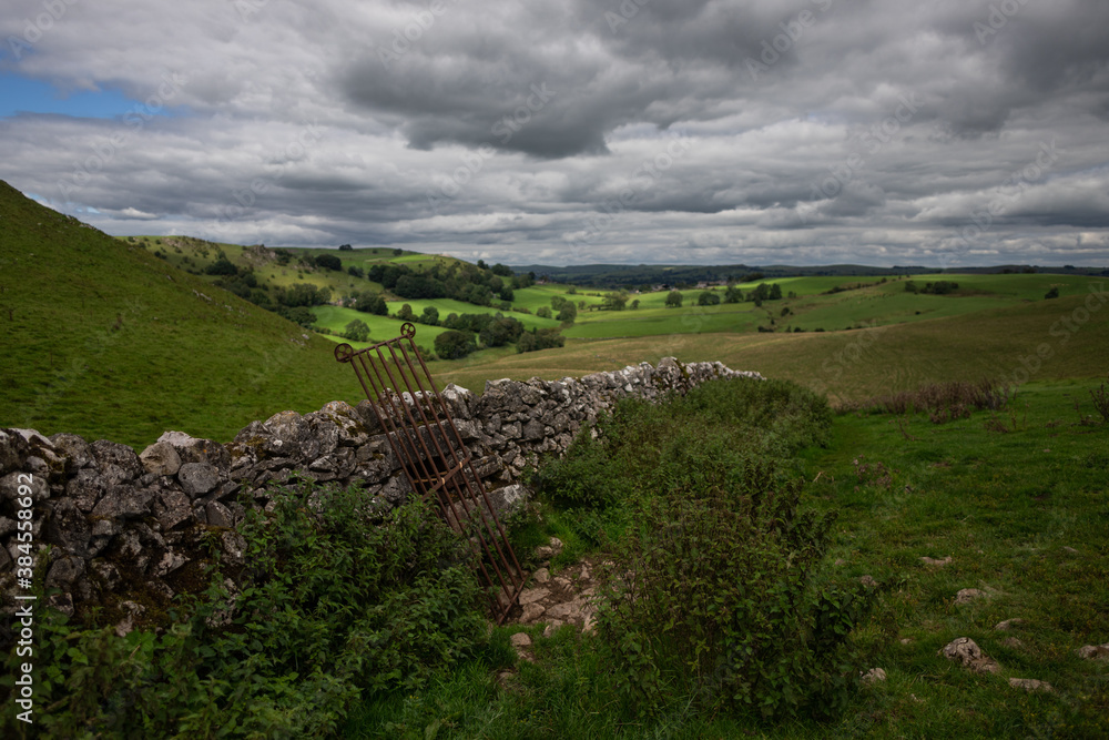 Old stone and iron farm wall in English countryside