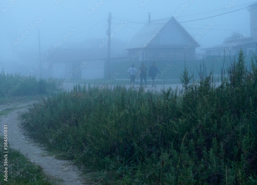 thick blue fog on the village road