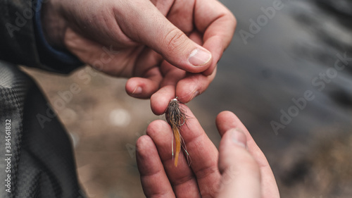 Fly fishing lures in fisherman hand