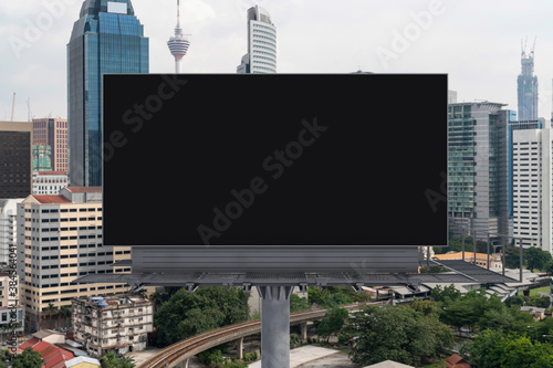 Canvas Print Blank black road billboard with Kuala Lumpur cityscape background at day time