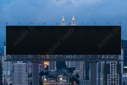 Canvas Print Blank black road billboard with Kuala Lumpur cityscape background at night time
