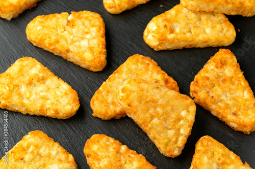 Fotografie Hash brown potato patties on rustic stone board