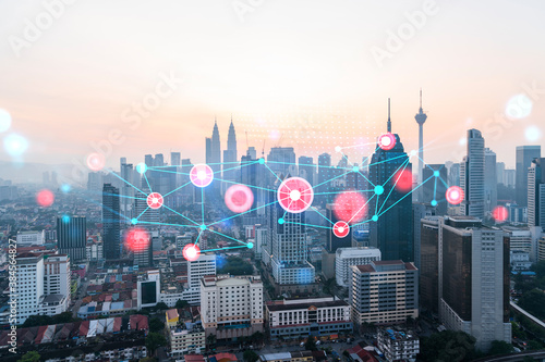 Canvas Print Hologram of abstract technology glowing icons, panoramic cityscape of Kuala Lumpur at sunset, Malaysia, Asia
