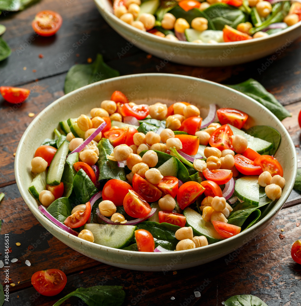 Chickpeas salad with tomato, cucumbers, red onion and greens. Dietary food. Vegan salad.
