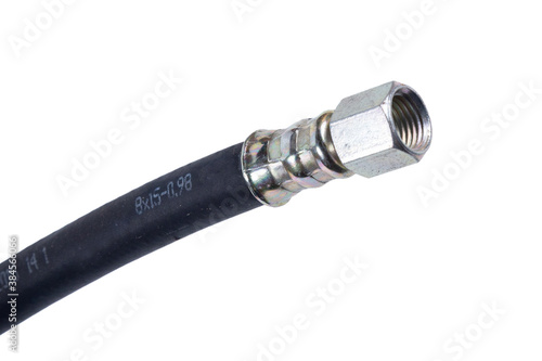 brake hose with a protective sheath for a truck, car accessories, auto parts, car brake system parts on a blue background close-up