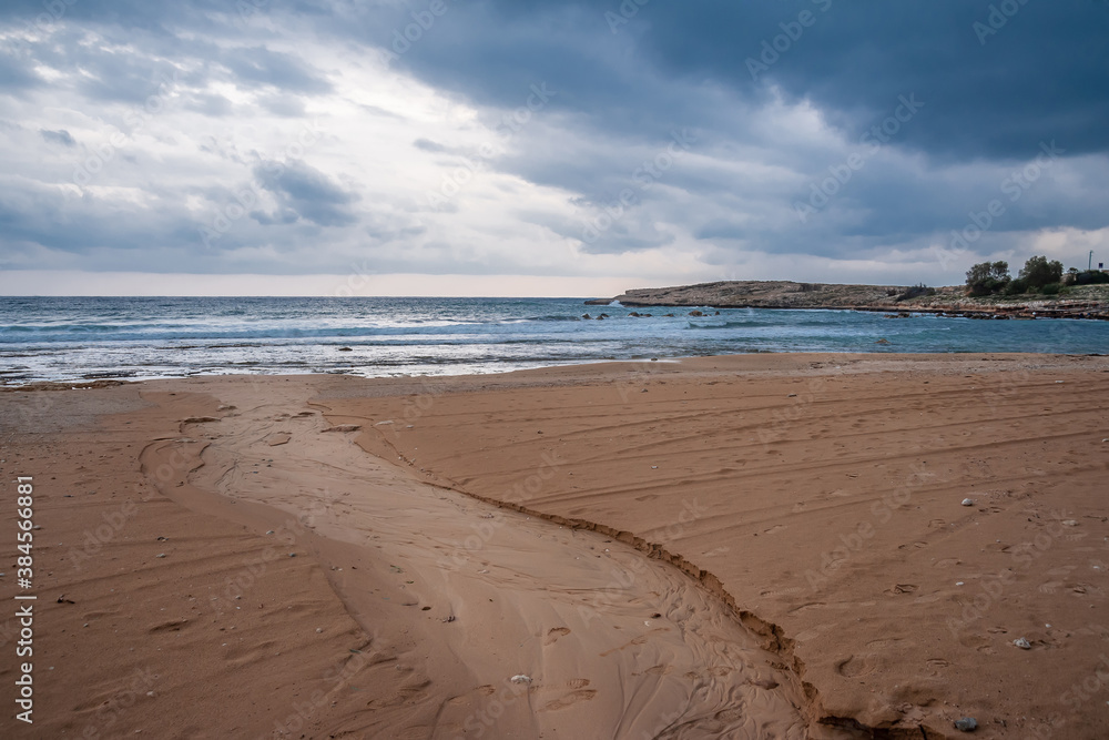 Sunset on the background of the sandy seashore