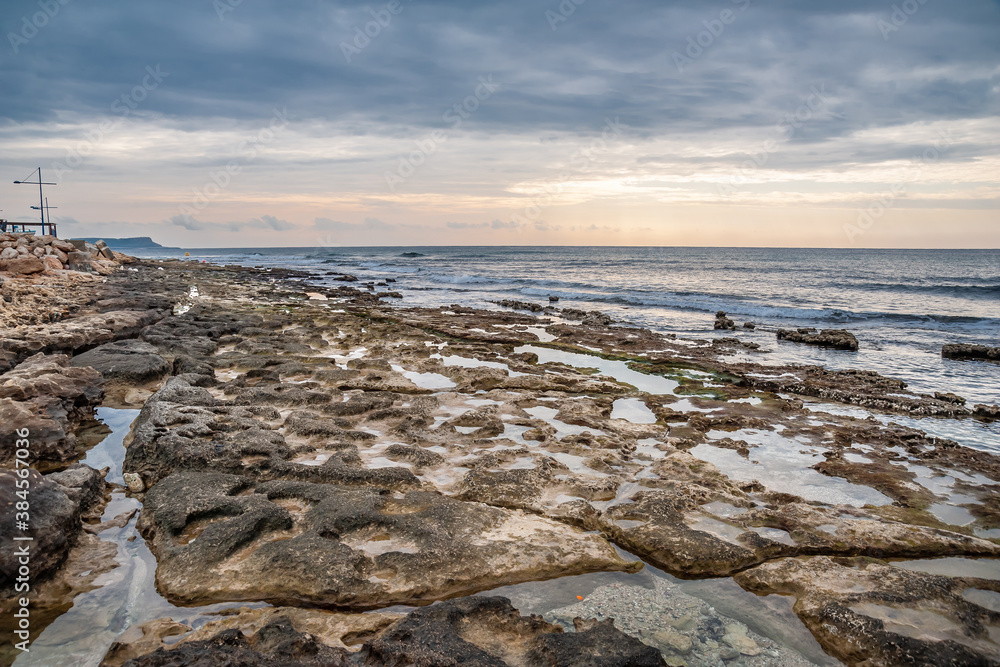 Sunset on the background of the rocky seashore. Sunset on the background of the rocky seashore.