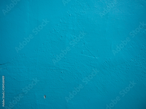 Entrance wall in blue paint. Texture of blue paint on cement and plaster © White_Rabbit