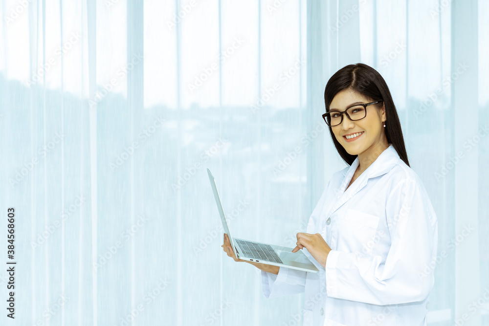 Portrait of beautiful scientist wearing black glasses holds a laptop or notebook computer. Portrait of beautiful scientist wearing black glasses holds a laptop or notebook computer.