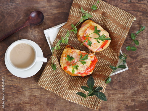 Home cooking. Healthy natural breakfast with hot cheese and tomato sandwiches and a cup of coffee.