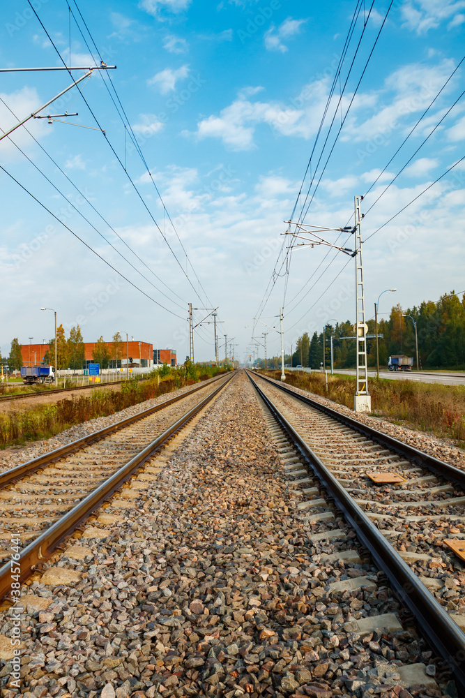 Fototapeta premium Two lane railroad with electric power lines