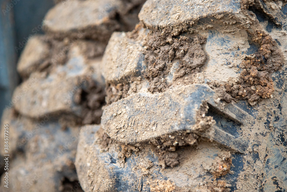 close up of the tire profile of an excavator, a lot of dirt in the profile close up of the tire profile of an excavator, a lot of dirt in the profile