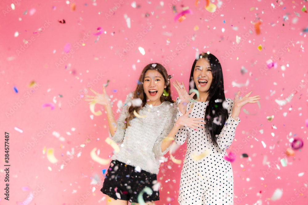 Portrait of two lovely cute asian women in christmas hats looking at camera isolated over pink background.Attractive asian woman smile in christmas, new year, valentine day, birthday . Portrait of two lovely cute asian women in christmas hats looking at camera isolated over pink background.Attractive asian woman smile in christmas, new year, valentine day, birthday .