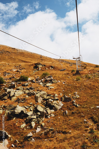 hill view. grassy mountainside. rise in height. ropeway. cable car