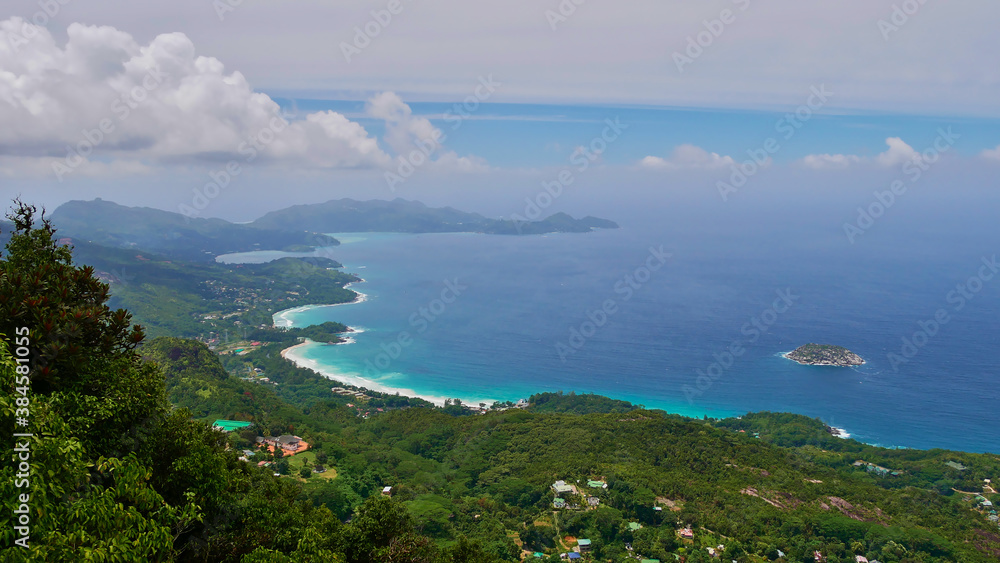 Panoramic view from the peak of mountain Morne Blanc, Mahe, Seychelles over the west coast and south of the island with rainforest and tropical beaches with turquoise colored water.
