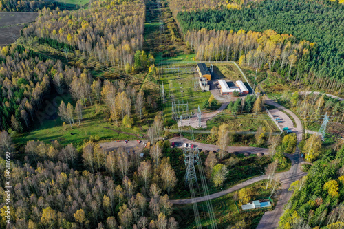 Aerial view of power distribution network with fall colors and forest and paths