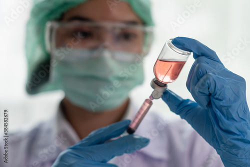 Female doctor holding syringe and vaccine  Science and chemistry  Healthcare and Medical concept