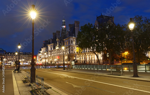 City Hall of Paris and bridge Arcole across Seine river at night, France.