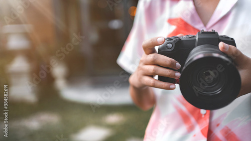 Close up of woman hands holding digital camera taking a photos, Female photographer.