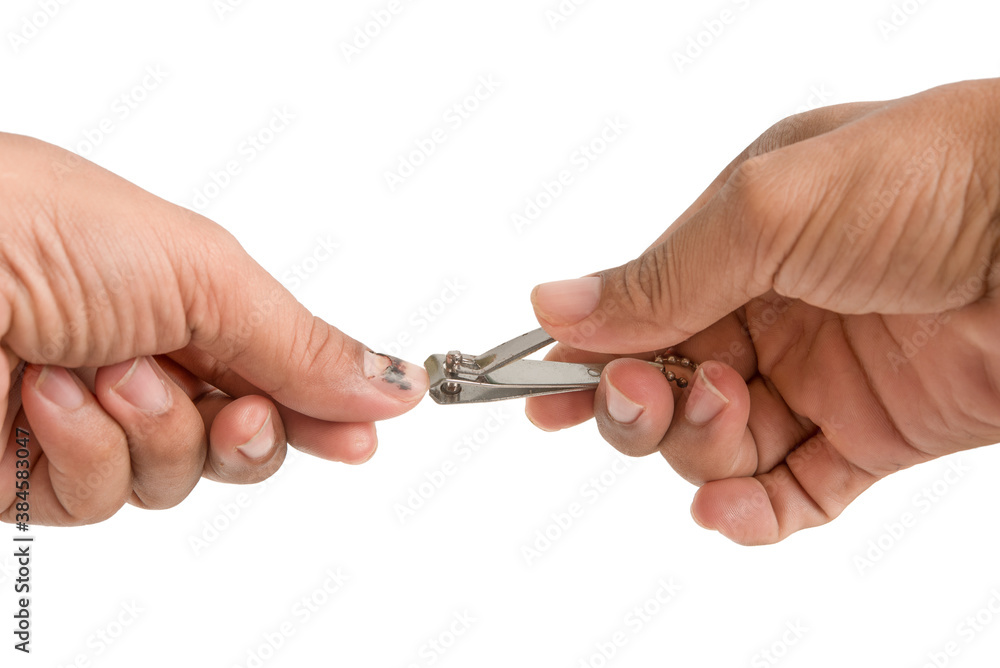 The hand that is cutting rotten nails isolated on white background. The hand that is cutting rotten nails isolated on white background.