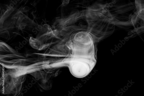 Clouds of white smoke on a black background, movement of smoke, smoke in the shape of a jellyfish