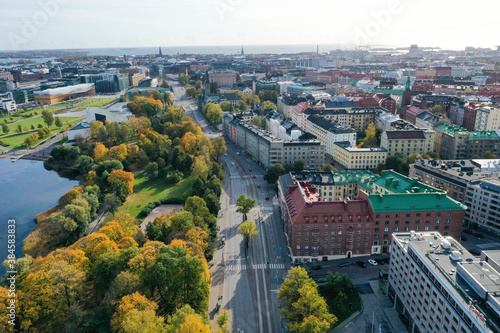 Aerial view of beautiful colorful old buildings in Helsinki, Finland. Fall color trees, park, sea shore and sunshine.