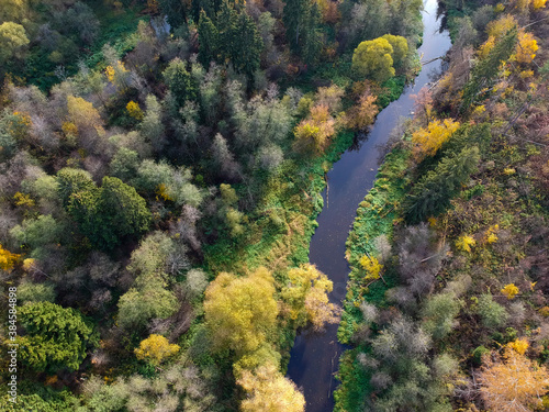 Aerial drone view of autumn forest and small river