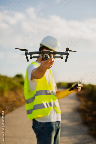 Drone operator Launching a drone on a countryside environment