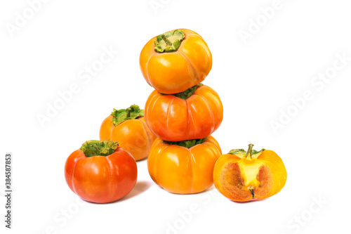 Diospyros kaki wholes and half. Persimmon fruits isolated on white background