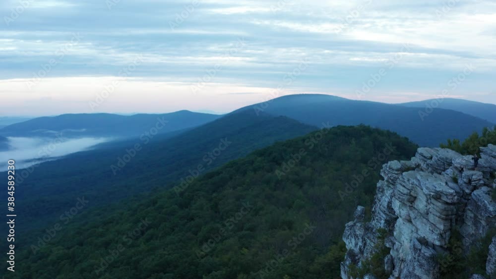 An aerial shot (dolly out) of Big Schloss, Great North Mountain and the Trout Run Valley at dawn in the summer, located on Virginia/West Virginia Border within the George Washington National Forest An aerial shot (dolly out) of Big Schloss, Great North Mountain and the Trout Run Valley at dawn in the summer, located on Virginia/West Virginia Border within the George Washington National Forest