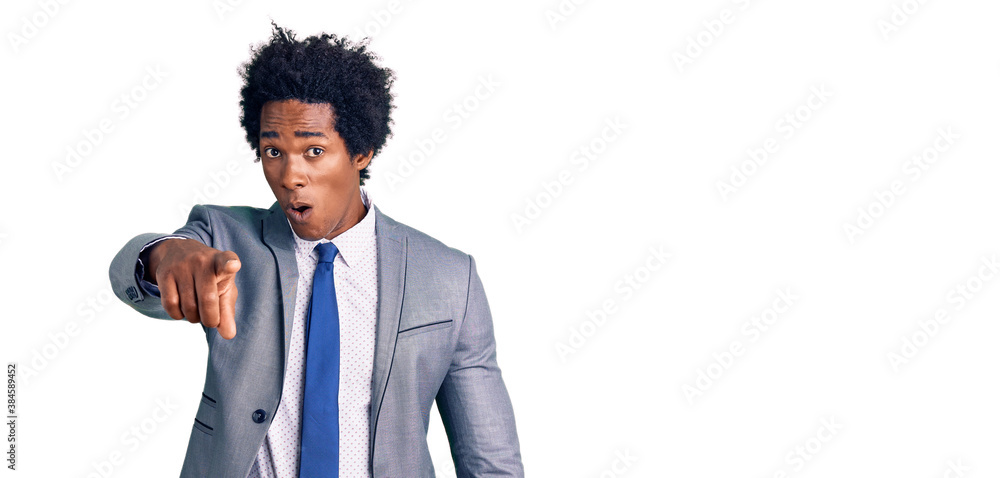 Handsome african american man with afro hair wearing business jacket pointing displeased and frustrated to the camera, angry and furious with you Handsome african american man with afro hair wearing business jacket pointing displeased and frustrated to the camera, angry and furious with you