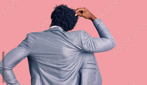 Handsome african american man with afro hair wearing business jacket backwards thinking about doubt with hand on head © Krakenimages.com