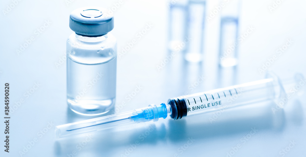 Medical syringe with a needle and a bollte with vaccine. Medical syringe with a needle and a bollte with vaccine.