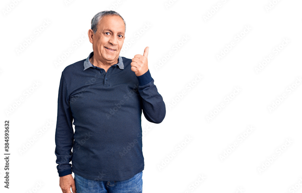 Senior handsome man wearing casual polo doing happy thumbs up gesture with hand. approving expression looking at the camera showing success. Senior handsome man wearing casual polo doing happy thumbs up gesture with hand. approving expression looking at the camera showing success.