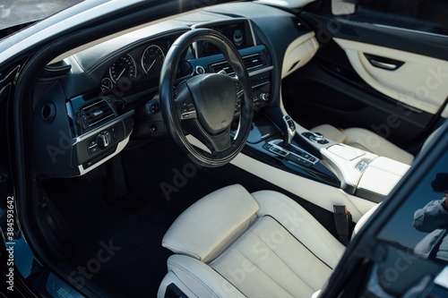 Car inside driver place. Interior of prestige modern car. Front seats with steering wheel © ruslan_shramko