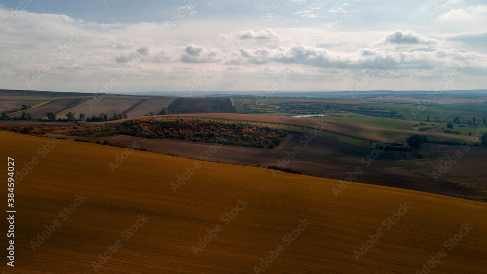 Aerial landscape in Moravia, Czech Republic. Sunrise over rolling hills in Moravia, aerial view of autumn landscapes and dramatic clouds.