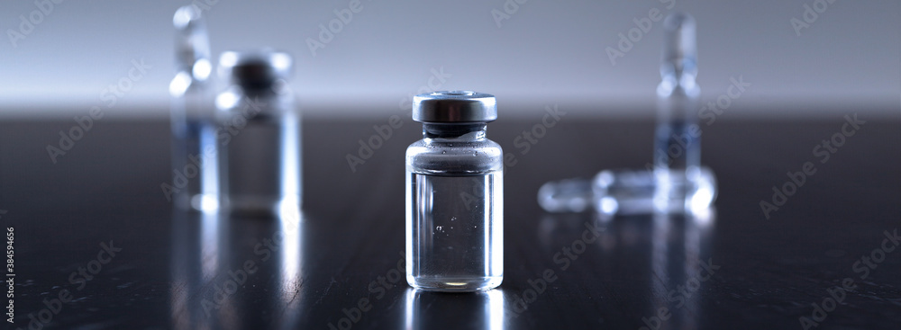 Medical syringe with a needle and a bollte with vaccine. - obrazy, fototapety, plakaty 