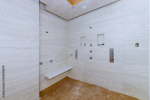 Fototapet Bathroom shower covered tiled in the apartment that is under construction, remod